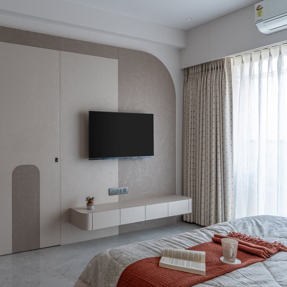 Bedroom detail with a rounded timber display niche